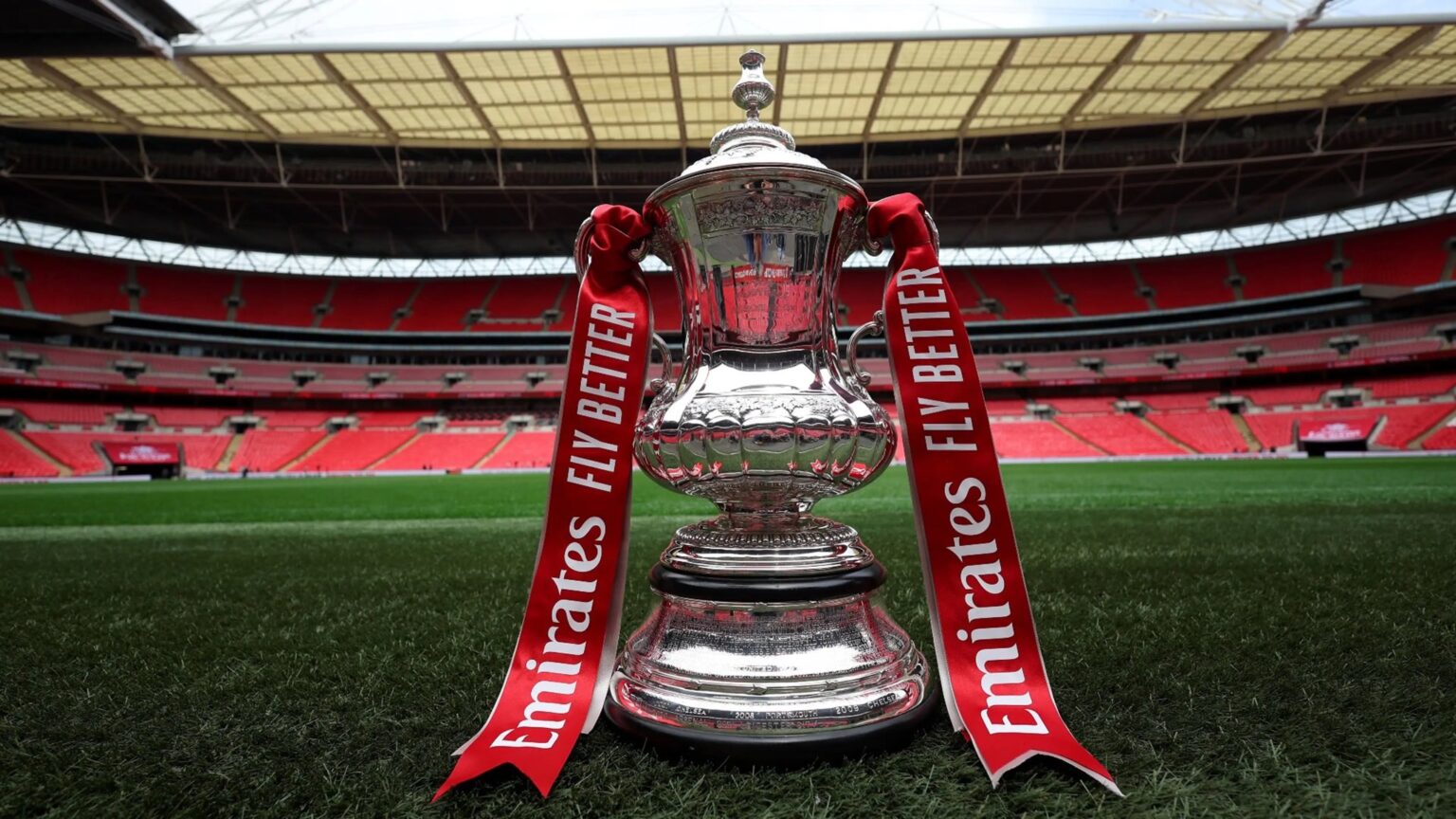 The FA Cup trophy prominently displayed at Wembley Stadium, showcasing its iconic design and rich history.