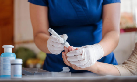 A picture of a nurse testing a patient for diabetes.