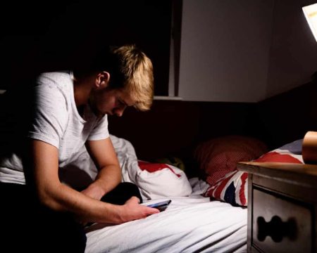A man making use of the internet through phone
