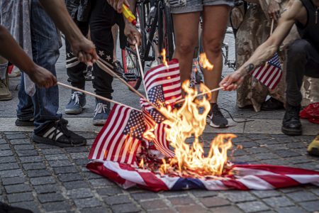 Trump signs order to prosecute flag burners