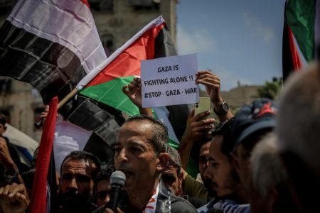 Palestinians gather in the Al-Rimal neighborhood to demand end to Israeli attacks and forced displacement in Gaza city.