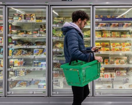 UK retailers warn tax rises could push shop prices higher A consumer trying to buy foodstuffs at the supermarket
