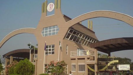 Over 5,000 UNIBEN students risk exam ban over unpaid fees University of Benin entrance gate with students walking past ahead of second-semester examinations.