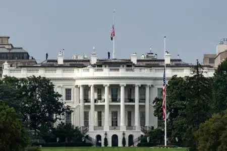National Guard troops and police officers stand behind yellow tape after a shooting incident close to the White House.