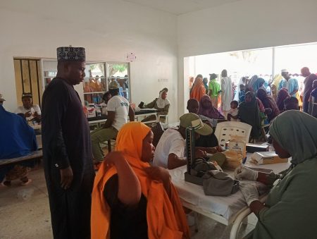 NYSC medical corps members attending to residents during a free healthcare outreach at Chamo Primary Health Care Centre in Dutse, Jigawa State.