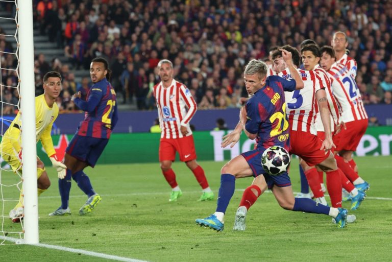 Barcelona players protest to the referee during a Champions League match following a disputed handball incident against Atletico Madrid.