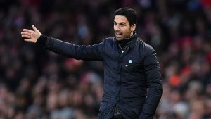 Mikel Arteta on the touchline during an Arsenal match, rallying his players amid a tight Premier League title race.