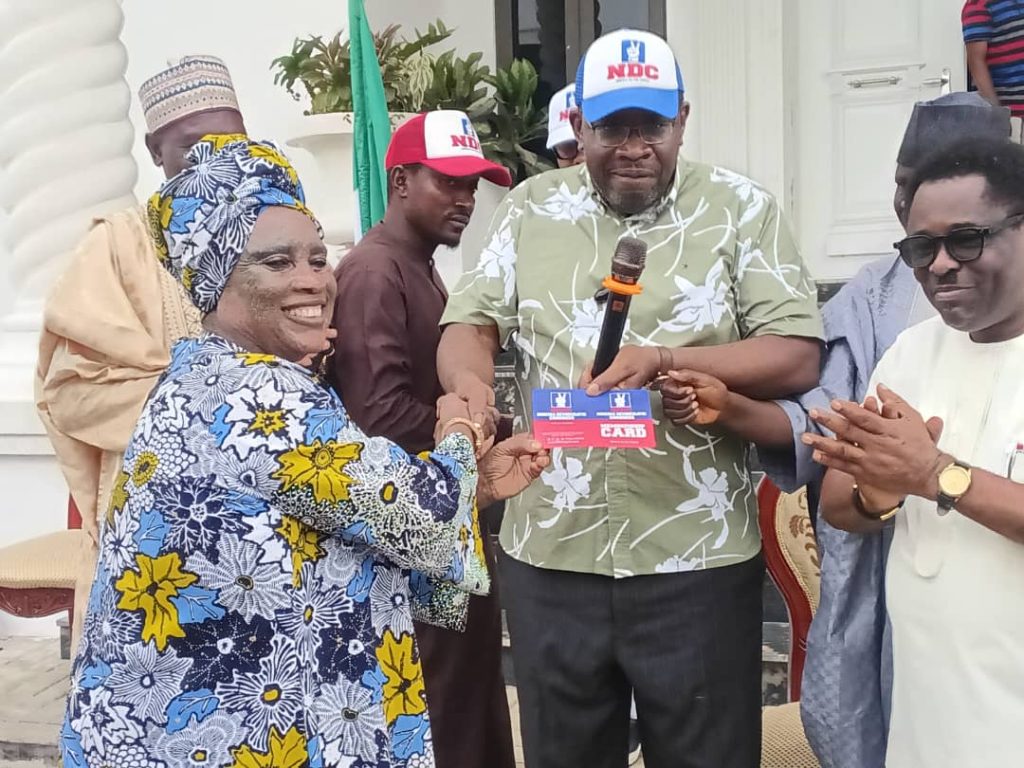 Seriake Dickson presenting NDC membership cards to defectors from ADC, LP, and SDP in Abuja.