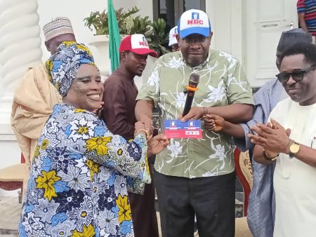 Seriake Dickson presenting NDC membership cards to defectors from ADC, LP, and SDP in Abuja.